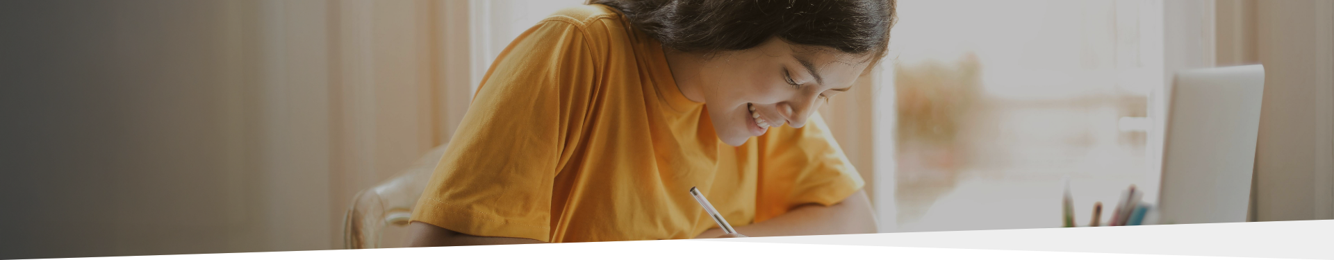 young person writing with a pen